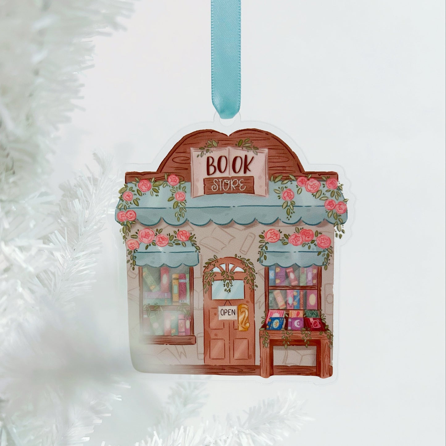 Decorative ornament shaped like a bookshop with flowers on a white textured background