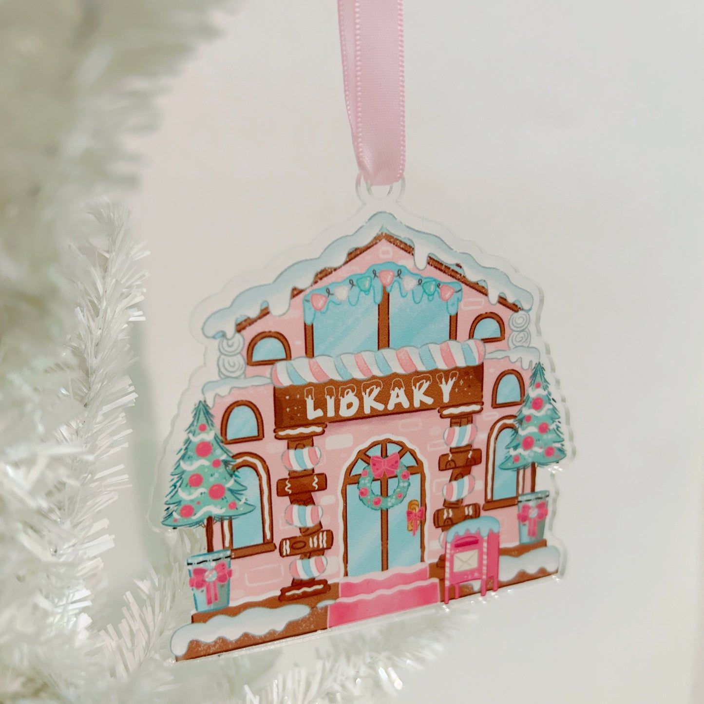 Decorative gingerbread house library ornament on a white background