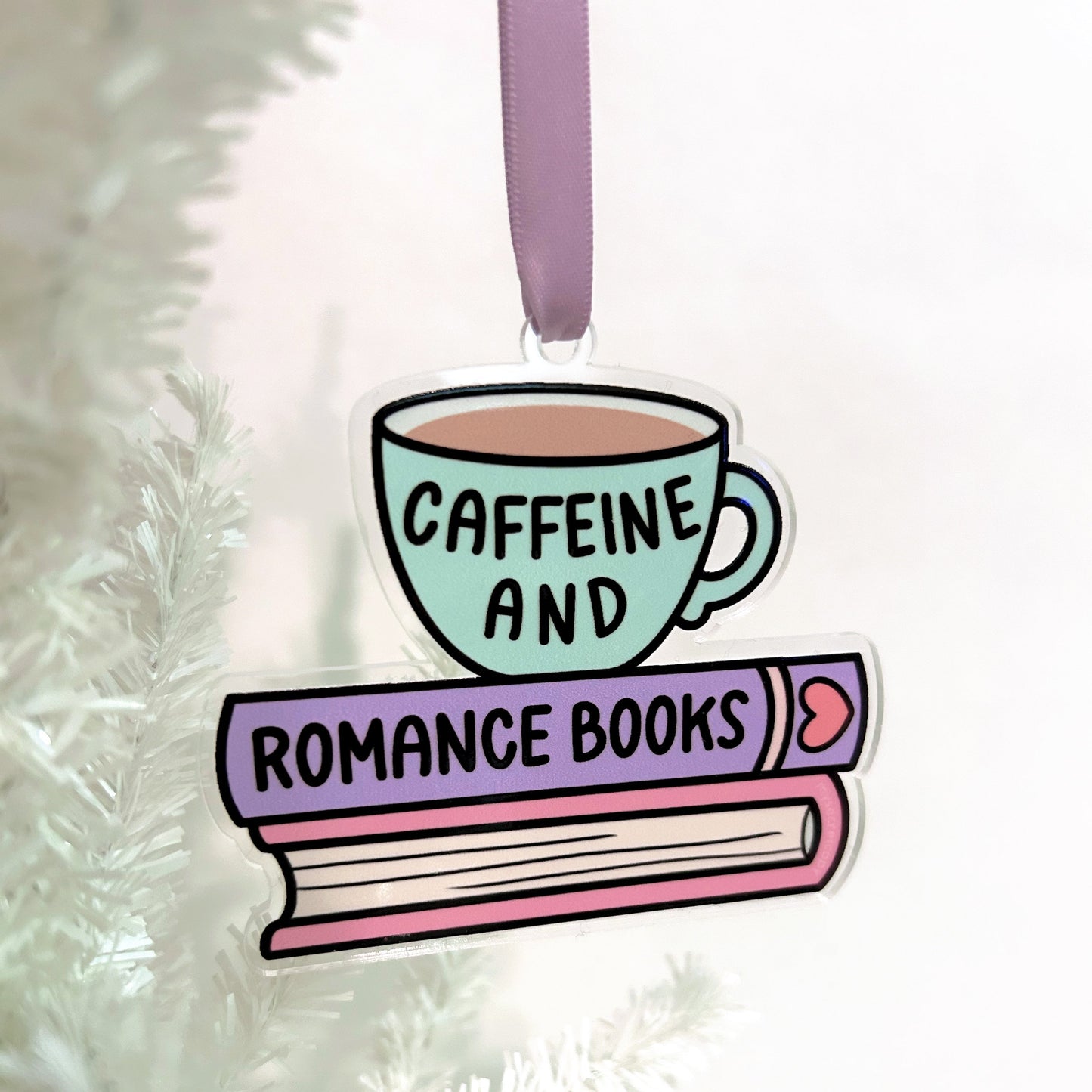 Decorative ornament with a cup and books design the reads: caffeine and romance books