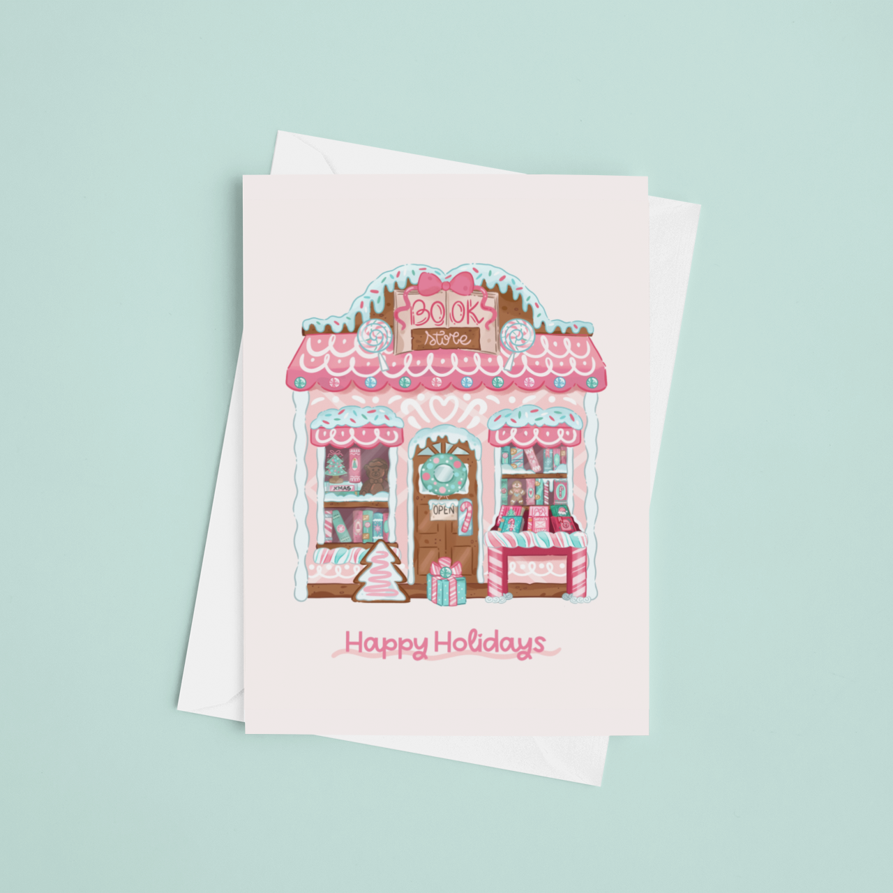 Greeting card with a gingerbread house design and 'Happy Holidays' text on a light blue background