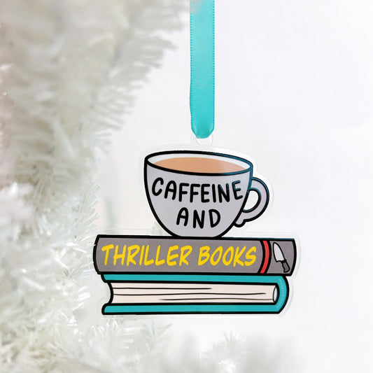 Decorative ornament with a cup labeled 'Caffeine' and books labeled 'Thriller Books' on a white fluffy background.