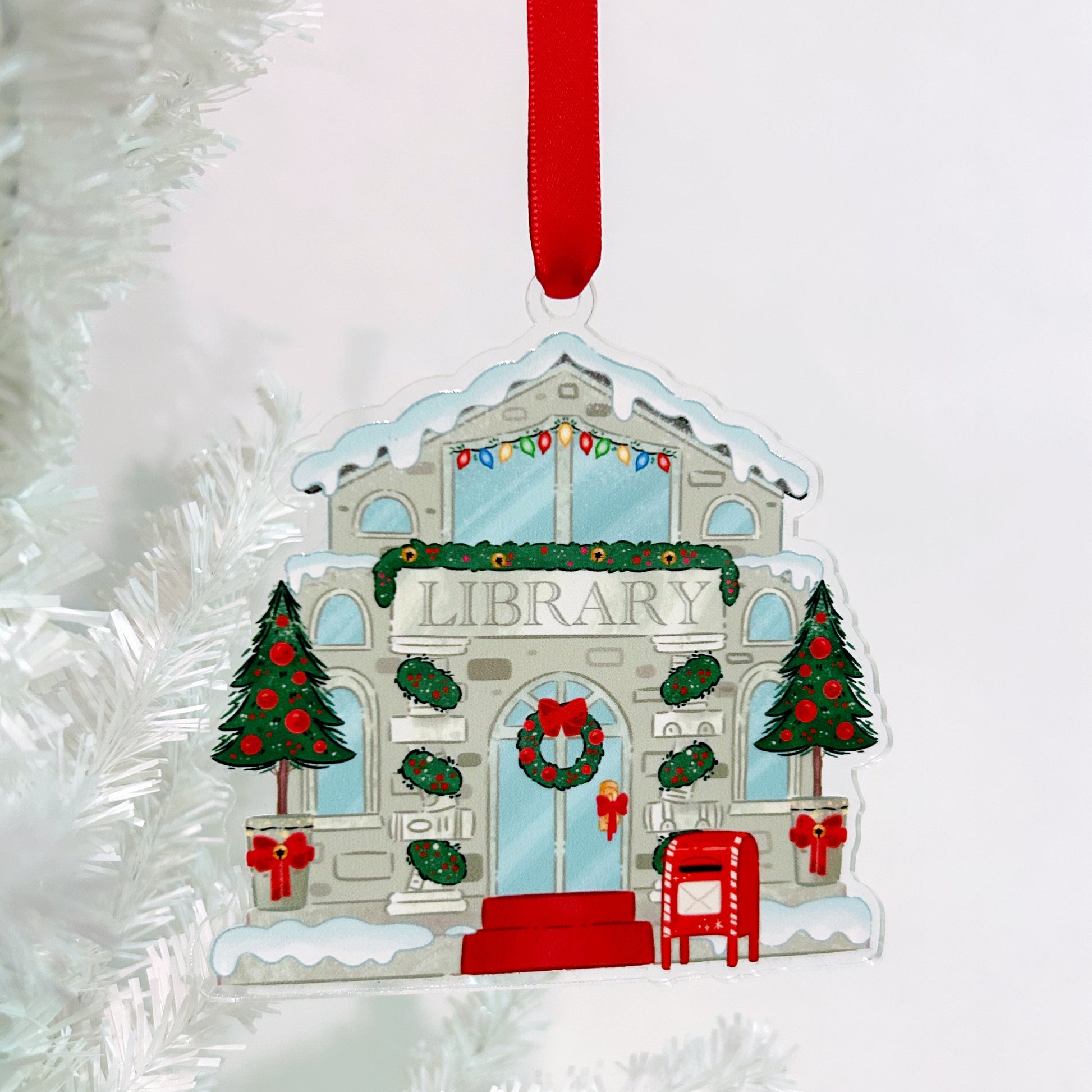 Christmas ornament of a library building with decorative elements on a white background