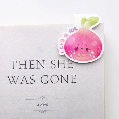 I cry a lot magnetic bookmark clipped on a book titled 'Then She Was Gone' by Lisa Jewell with a decorative sticker on a white background