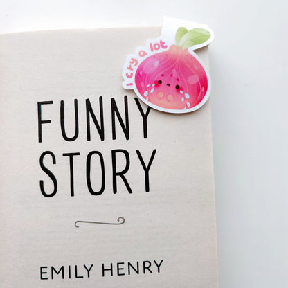 I cry a lot magnetic bookmark clipped on a book titled 'Funny Story' by Emily Henry on a white background