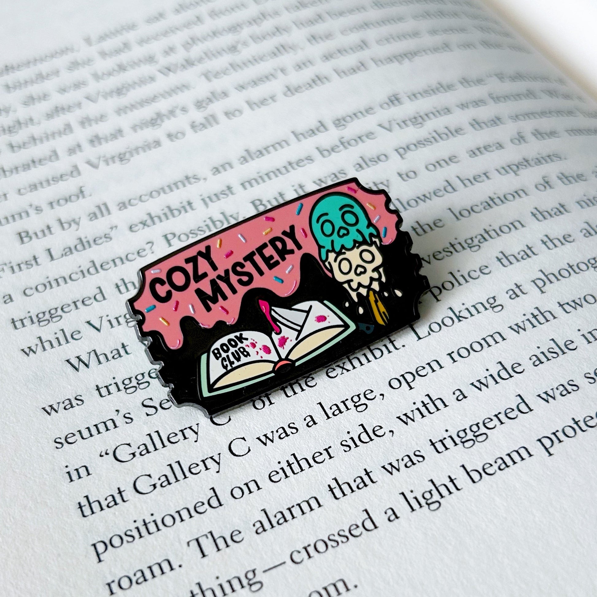 Pin with cozy mystery book club design on an open book