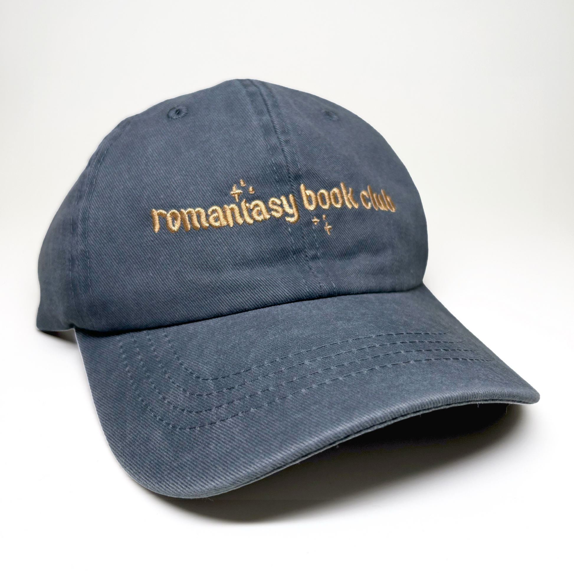 A gray cotton baseball cap with 'romantasy book club' embroidered in gold across the front, shown on a clean white background.