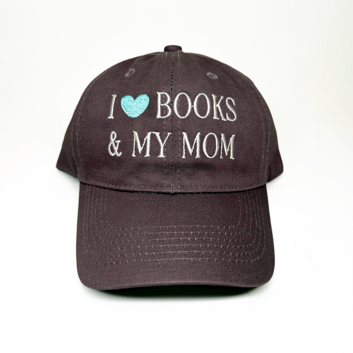 A baseball cap with embroidered text reading 'I [light blue heart] BOOKS & MY MOM' on the front, shown against a plain white background.