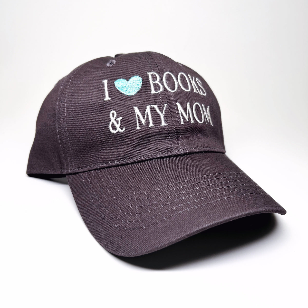 A dark gray baseball cap with embroidered text reading 'I [light blue heart] BOOKS & MY MOM' on the front, shown on a clean white background.