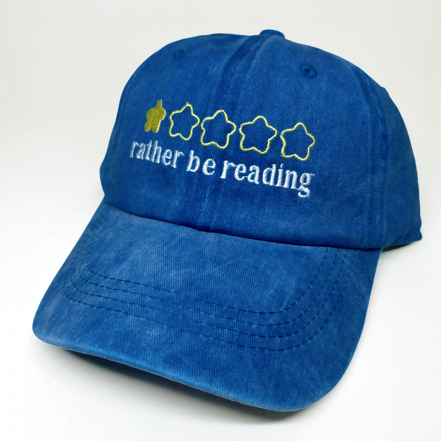 A blue denim baseball cap with embroidered text reading 'rather be reading' and 5 stars graphic on the front, shown on a plain white background.