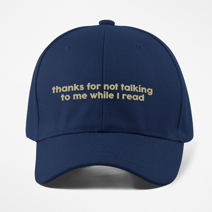 Navy blue cap with yellow text on a white background